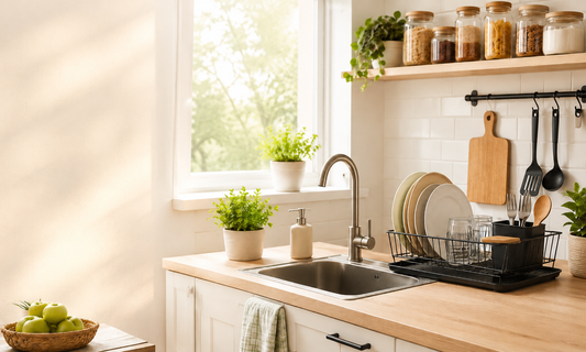 Organized kitchen sink area with dish rack, plates, utensils, jars, and clean countertop