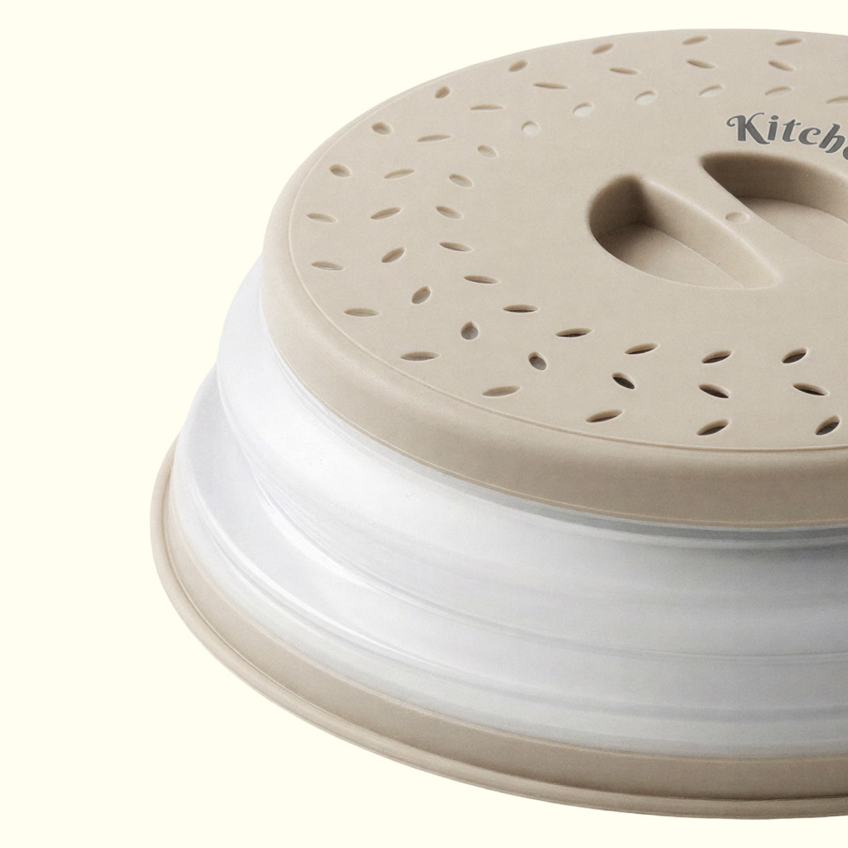 Beige collapsible microwave cover with steam vents for reheating food